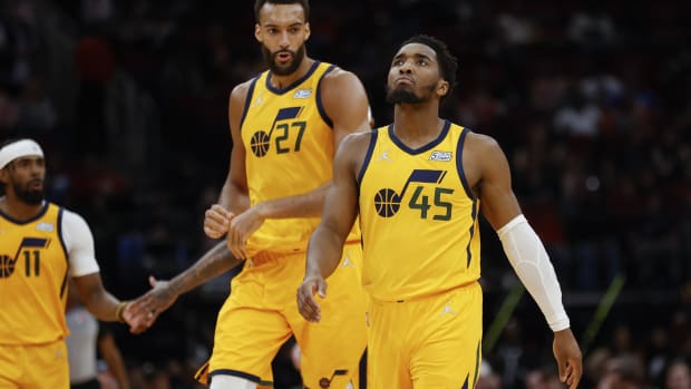 Utah Jazz guard Donovan Mitchell (45) and center Rudy Gobert (27) react after a play during the third quarter against the Houston Rockets at Toyota Center.